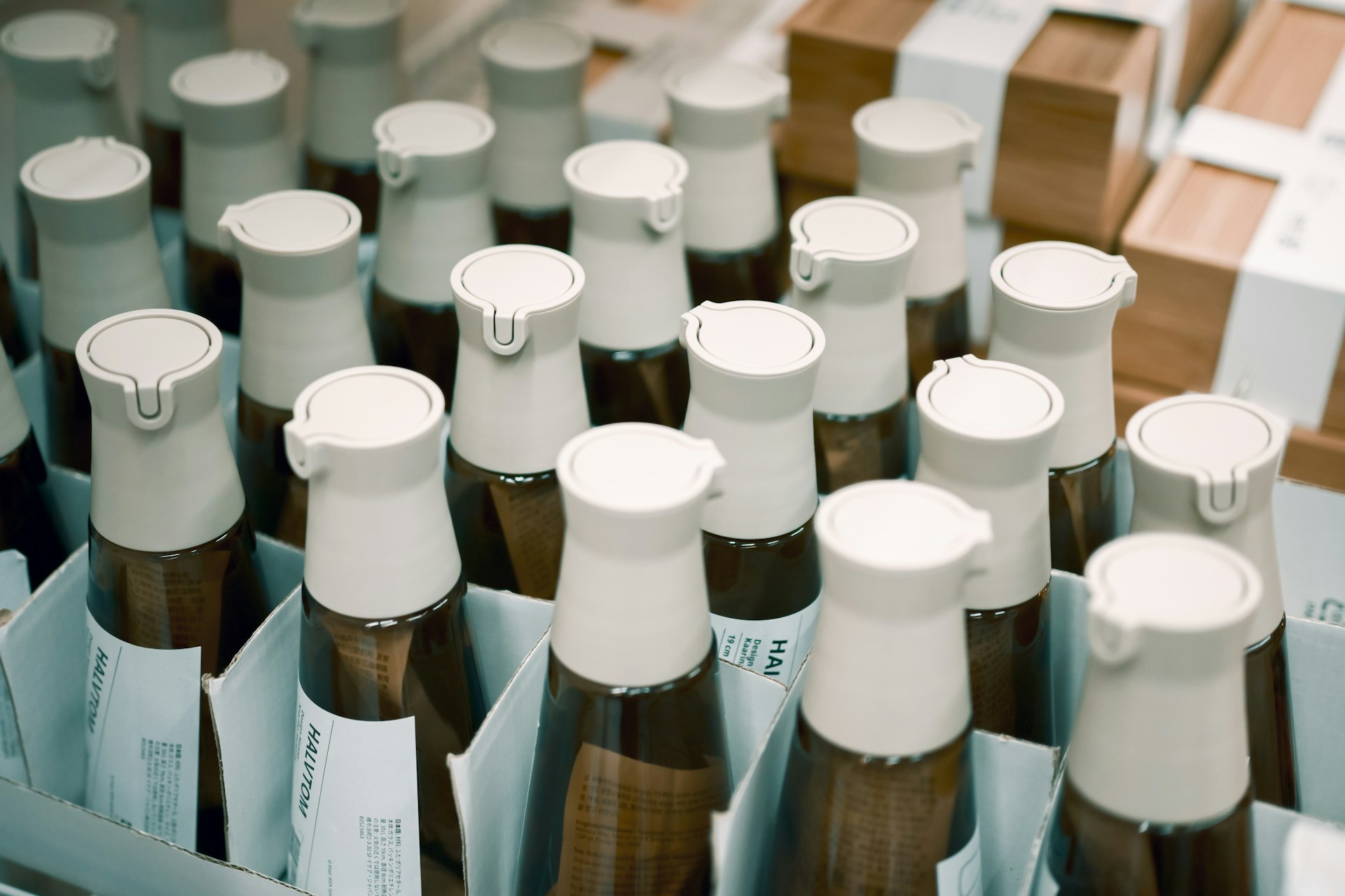 Many bottles with white caps in a box